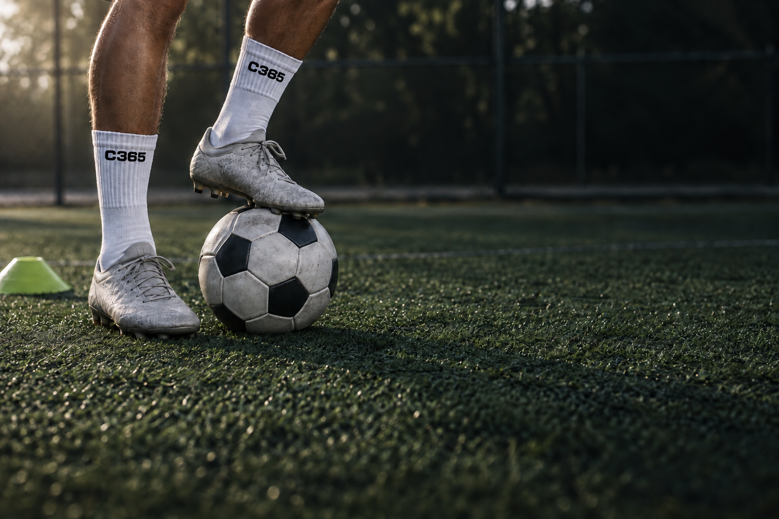 Football player controlling a ball beside a training cone in a small space